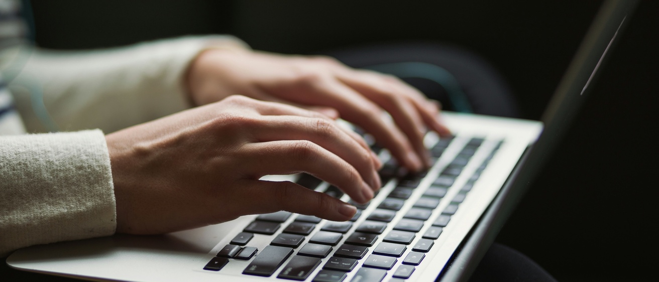 Person typing on a keyboard